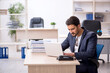 © Elnur - Young handsome employee working in the office