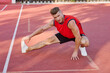 © VICHIZH - athletic man doing exercises outdoors sports field exercise