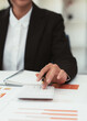 © PaeGAG - Close up hand of businessman or accountant hand holding pen working on calculator to calculate business data, accountancy document and laptop computer at office, business concept.