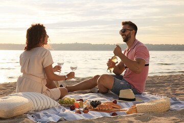 Sticker - Lovely couple having picnic near river on sunny day