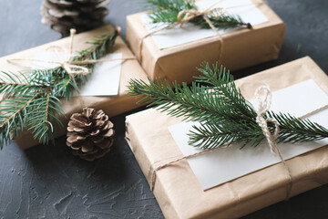 minimal style christmas wrapping of gifts. paper present decor. eco gifts with natural fir tree decoration on grey background