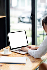 Fototapete - Cropped shot of young woman working on portable tablet, vertical view.