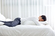 © 이 상신 - An office worker in his 30s who is sleeping on a weekend bed.