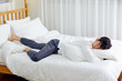 © 이 상신 - An office worker in his 30s who is sleeping on a weekend bed.