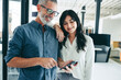 © Jacob Lund - Modern businesspeople using a smartphone together