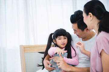 happy love family lifestyle with asian father and mother and child daughter at home together
