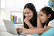 © chokniti - education at home, young mother and child family learning to work a homework with laptop