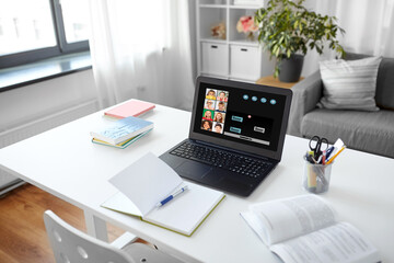 Sticker - education, school and distant learning concept - open laptop computer with group of students on screen, notebook and book on table at home