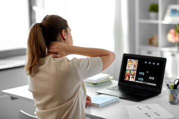 Sticker - distant education, remote job and health concept - tired female teacher having online class with group of students on laptop computer and touching her aching neck at home office