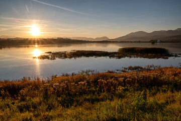 Wall Mural - Mirror reflection of sun on the lake surface