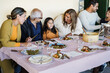 © DisobeyArt - Happy latin family having fun eating together at home- Focus on grandmother face