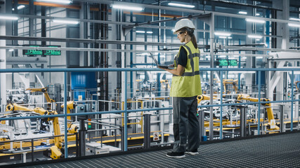 Aufkleber - Female Car Factory Engineer in High Visibility Vest Using Laptop Computer. Automotive Industrial Manufacturing Facility Working on Vehicle Production with Robotic Technology. Automated Assembly Plant.
