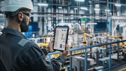 Aufkleber - Car Factory Engineer in Work Uniform Using Tablet Computer with Electrical Blueprints and Schemes. Male Specialist in Automotive Industrial Manufacturing Facility Working on Automobile Production.