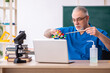 © Elnur - Old male teacher chemist in the classroom