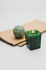 Poster - green scented candle in a glass with Christmas time decorations