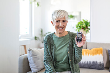 Blood sugar testing at home. Checking Blood Sugar Level At Home. Diabetic Checking Blood Sugar Levels. Woman checking blood sugar level by glucometer and test stripe at home