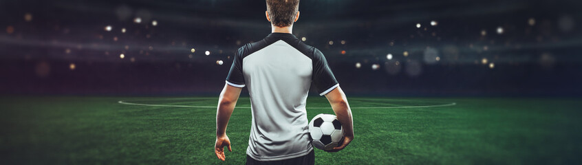 Wall Mural -  The concept of playing football.soccer player with Football on soccer field.