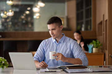 Wall Mural - smiling businessman having virtual team meeting call, talking, remotely working at home watching online learning training webinar in remote office