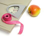 © freeman83 - Scales with measuring tape and apple, symbol and concept weight loss, sports and fitness.