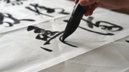 Wall Mural - an old calligrapher is writing calligraphy and writing calligraphy