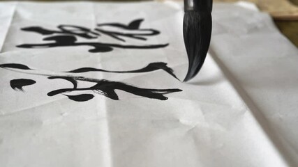 Wall Mural - an old calligrapher is writing calligraphy and writing calligraphy