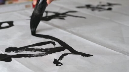 Wall Mural - an old calligrapher is writing calligraphy and writing calligraphy
