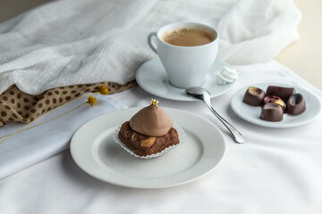 Wall Mural - Chocolate cake portion with cup of coffee on the white table