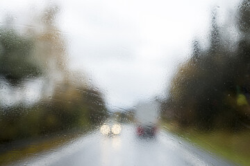 Canvas Print - Driving with no windscreen wipers in heavy rain with oncoming traffic. Unwiped rain water off