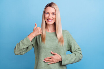 Photo of attractive mature woman arm on belly healthy show thumb-up great suggest advert isolated over blue color background