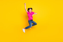 Photo Of Excited Small Girl Jump Enjoy Horse Rodeo Wear Pink T-shirt Jeans Shoes Isolated Yellow Color Background