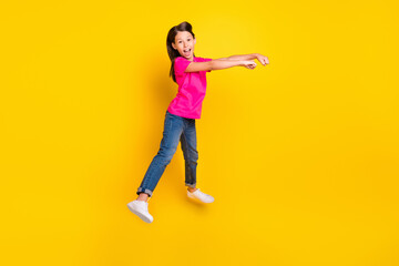 Sticker - Photo of positive little cowgirl jump pretend ride horse wear pink t-shirt jeans shoes isolated yellow color background