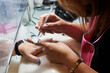 © Cristian Blázquez - Professional manicurist fixes and beautifies a client's nails