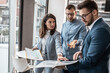 © BalanceFormCreative - Group of company coworkers at the office discuss about business strategy of new investments.