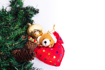 Poster - Christmas arrangement with a stuffed teddy bear, golden Christmas ball, and pine tree branches