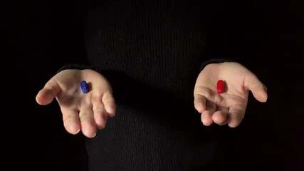 Wall Mural - Offering a Red pill or a blue pill. Human hands hold red and blue pills. Dark background. Studio shot 4K footage