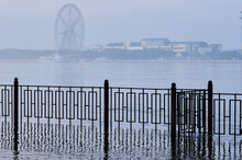 Ferris Wheel In Blur. The Amur River From The Side Of Russia. View Of China. Morning Fog Blurs The Ferris Wheel.