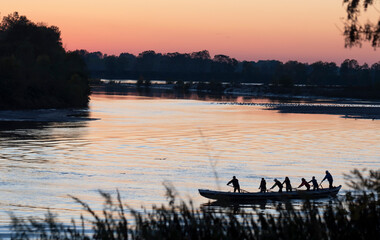 Wall Mural - Boats on the Po river at sunset, Autumn, Cremona