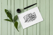 © Pixel-Shot - Paper with Arabic text and tools for calligraphy on wooden background