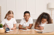 © Pixel-Shot - Little pupils studying online at home