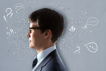 Poster - Portrait of attractive young european businessman on grey wall background with arrows and thought icons sketch. Solution, direction, success and brainstorm concept.