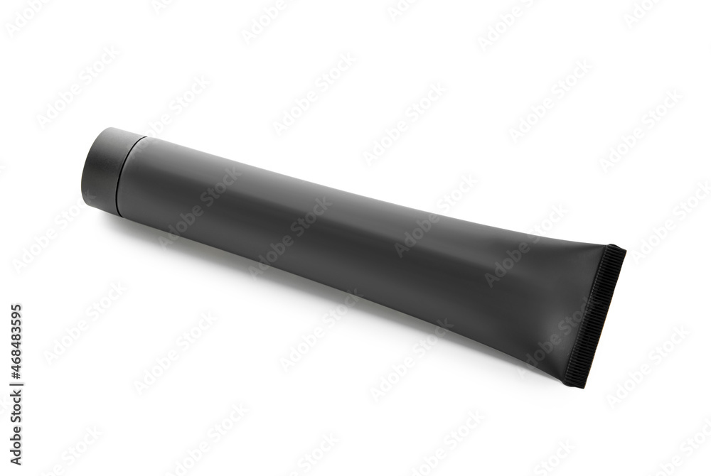 Tube of black toothpaste with activated carbon on white background