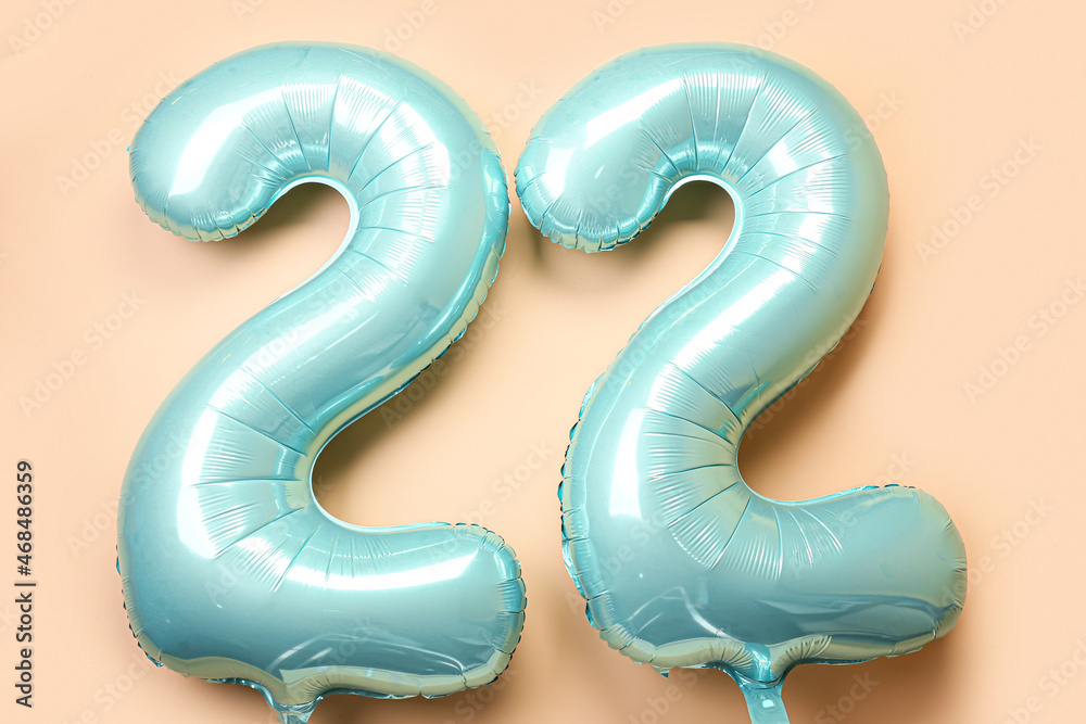 Figure 22 made of balloons on beige background