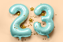 Figure 23 Made Of Balloons And Confetti On Beige Background