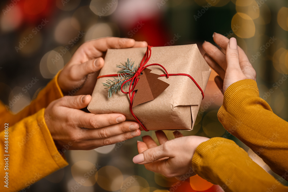 Women with present at home on Christmas eve, closeup