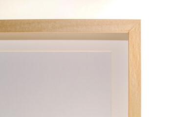 Closeup shot of the corner of a wooden picture frame with a blank white picture inside