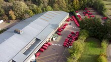Flying Over Royal Mail Sorting Office In Canterbury With Red Delivery Vans - Dolly Forward
