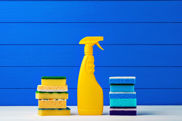 Wall Mural - Stack of new cleaning sponges and liquid detergent against blue wooden background