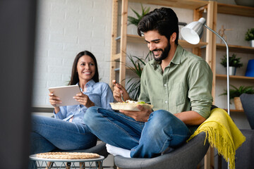 Canvas Print - Young happy couple having a good time together in a cozy home