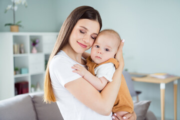 Poster - Photo of shiny dreamy mother dressed white t- holding hands arms child closed eyes smiling inside indoors apartment room