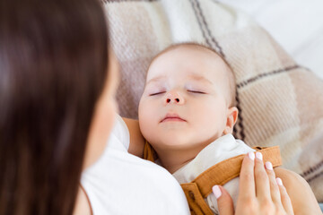 Wall Mural - Cropped photo of caring lovable pretty mother comfort baby kid sleep wear white t-shirt home indoors